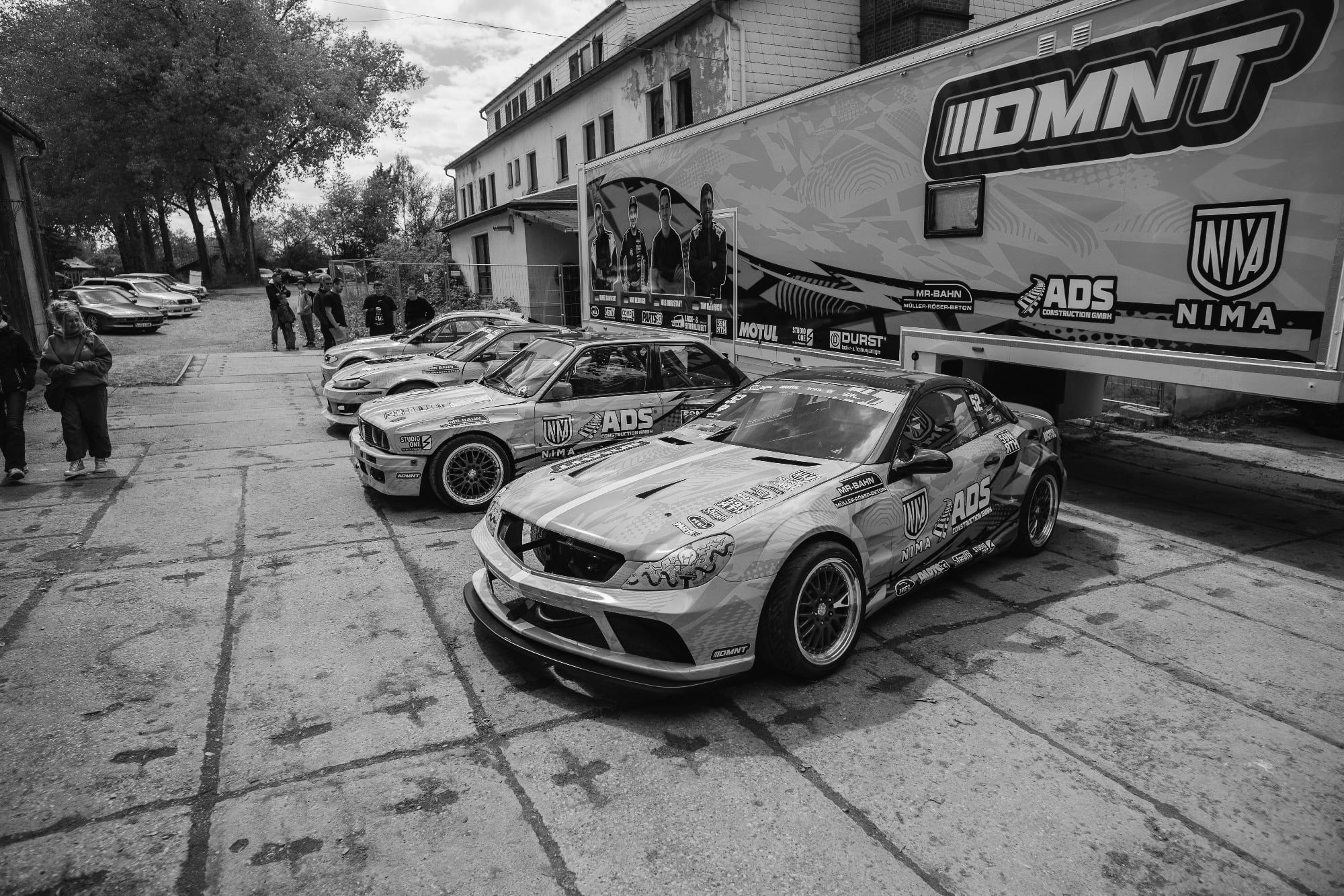 Rennwagen des DMNT-Motorsportteams mit Designfolierung in Türkis und Pink von STUDIO ONE